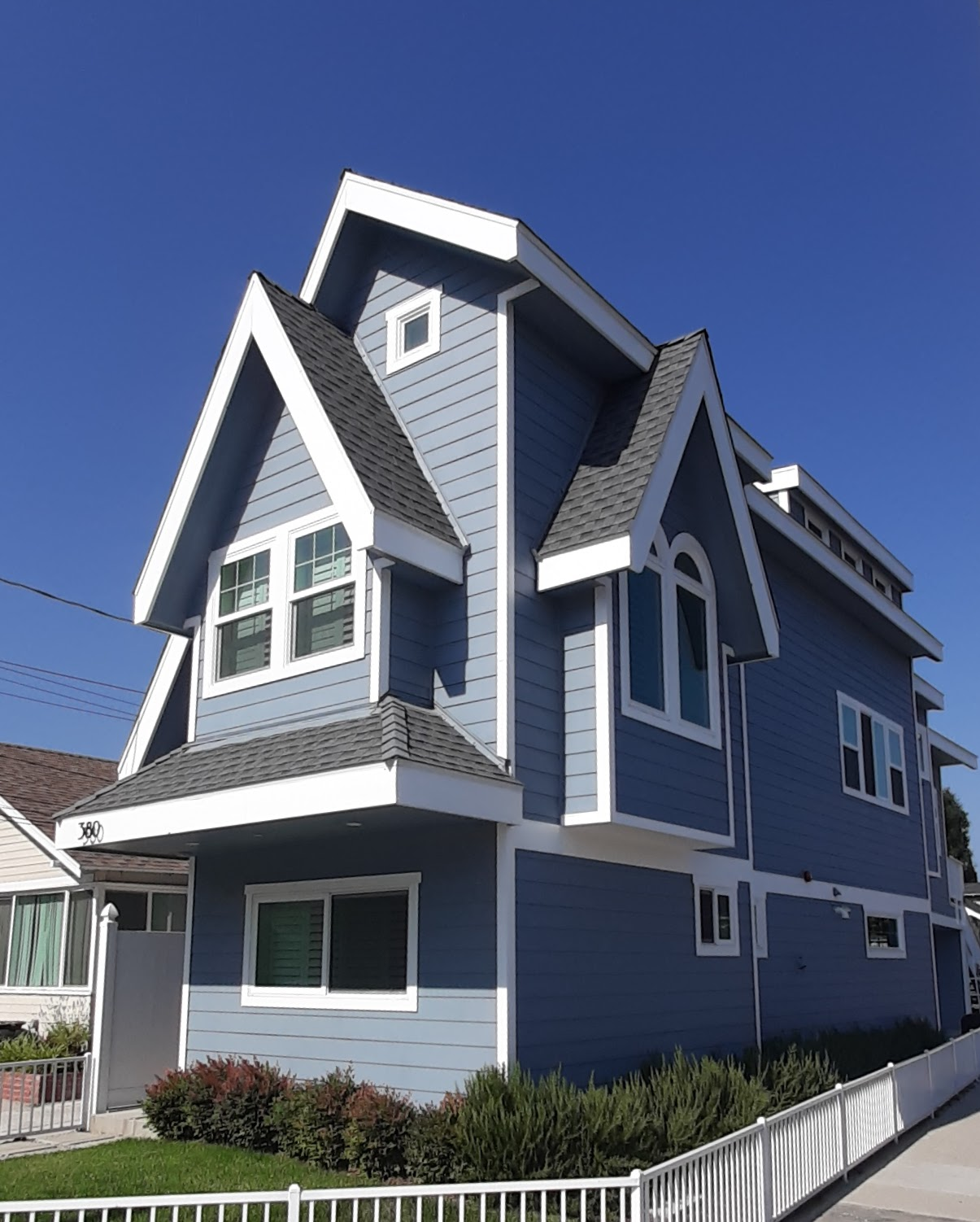 Big Little House by Architecture JHK, a blue narrow-lot home in Pasadena with steep gabled roofline
