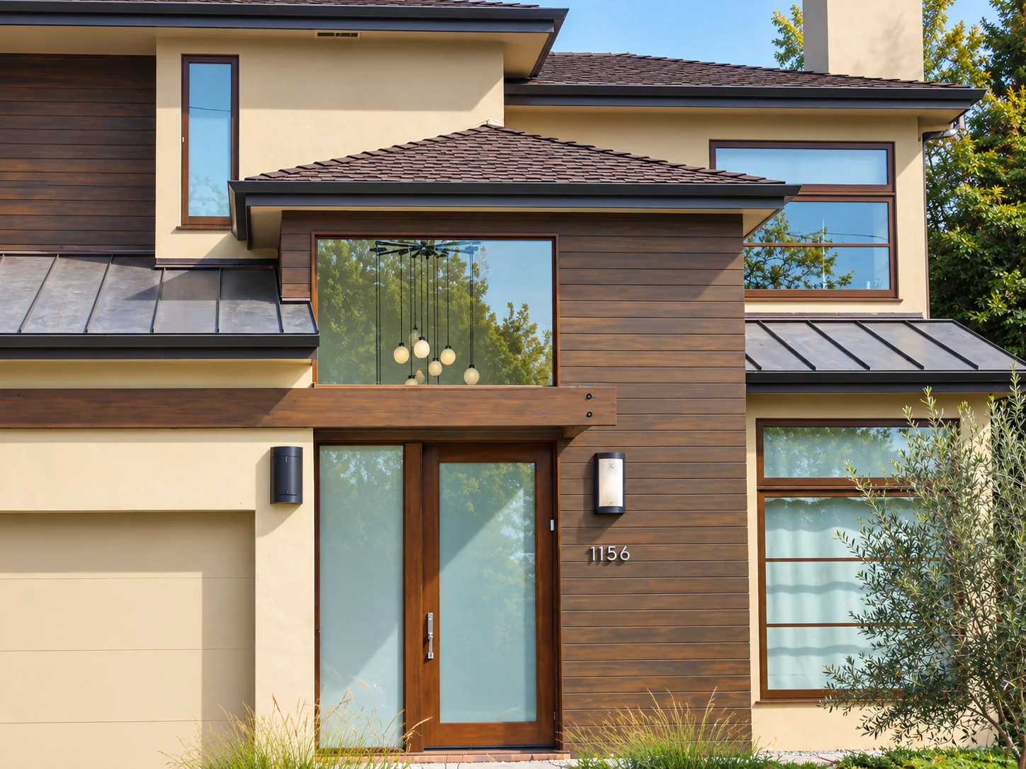 Modern contemporary two-story home in Pacific Palisades with dark wood siding, standing-seam metal roof, and glass entryway