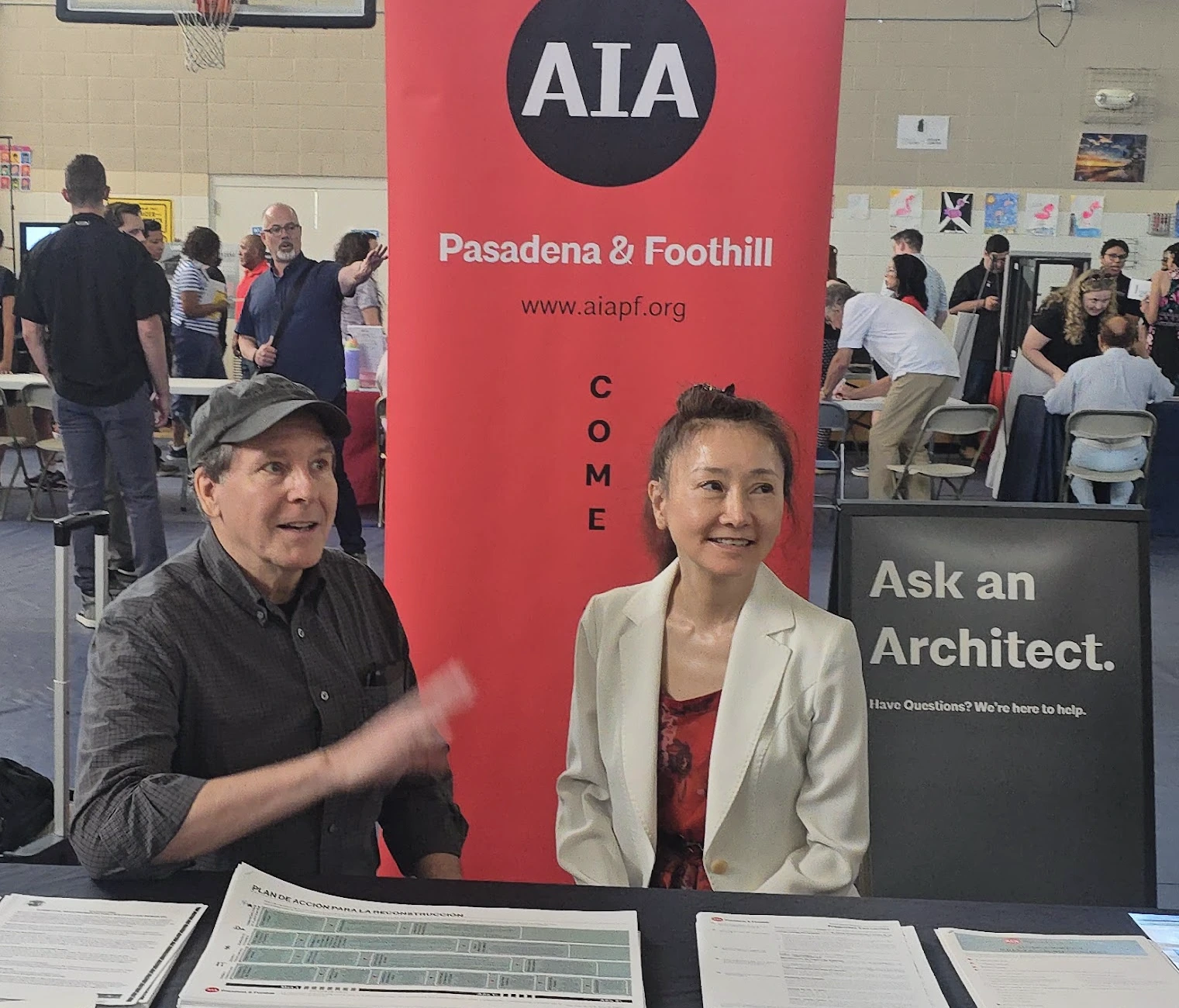 Matt Steele and Jane Kim Keener of Architecture JHK volunteering at the AIA, American Institue of Architects, "Ask an Architect" table, helping homeowners with rebuilding